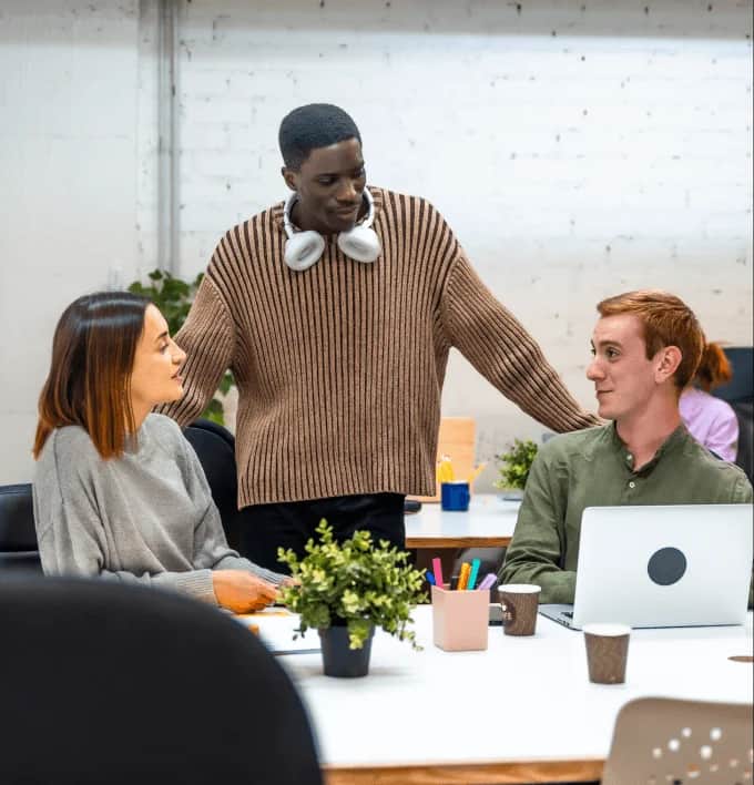 People in meeting room around table