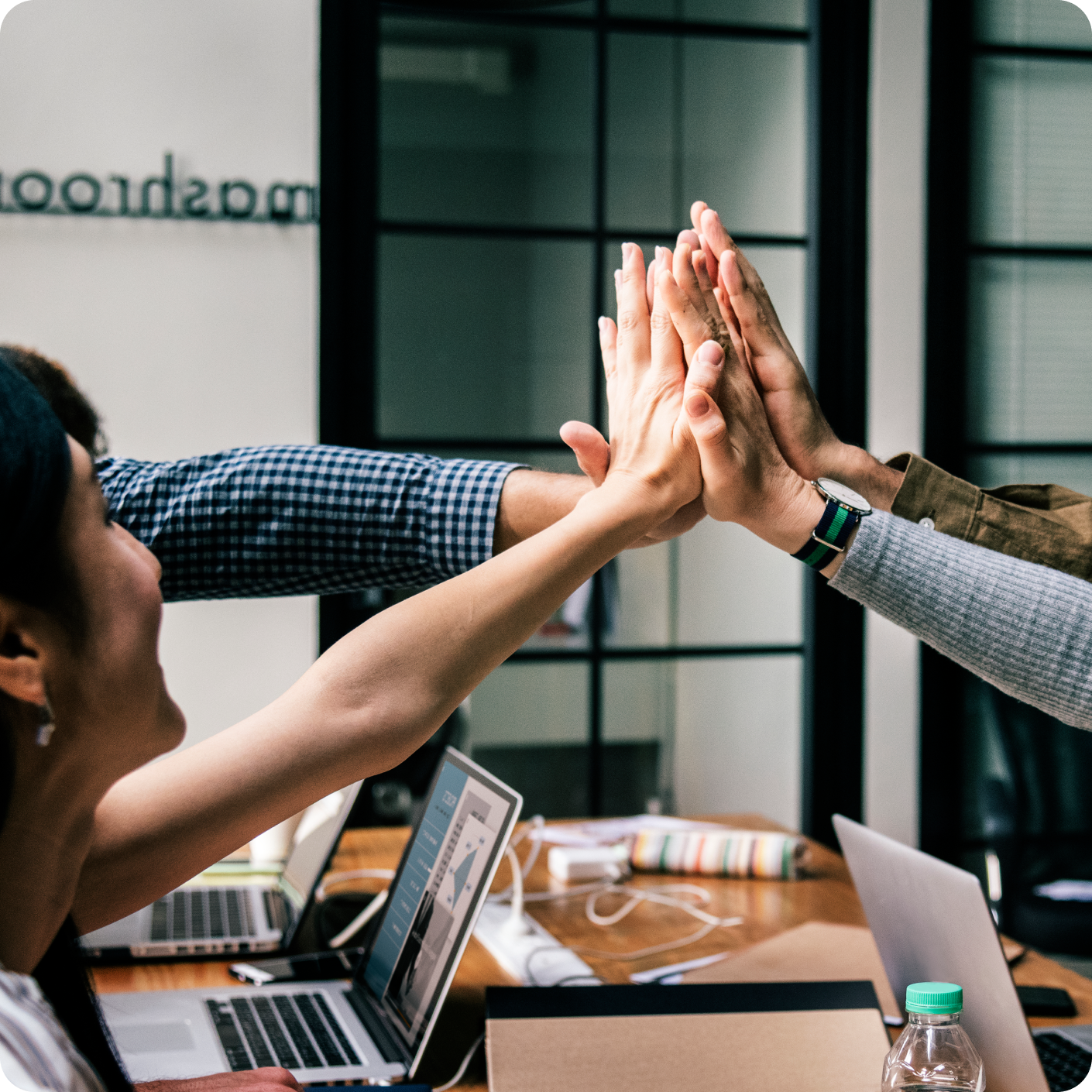 four people high-fiving