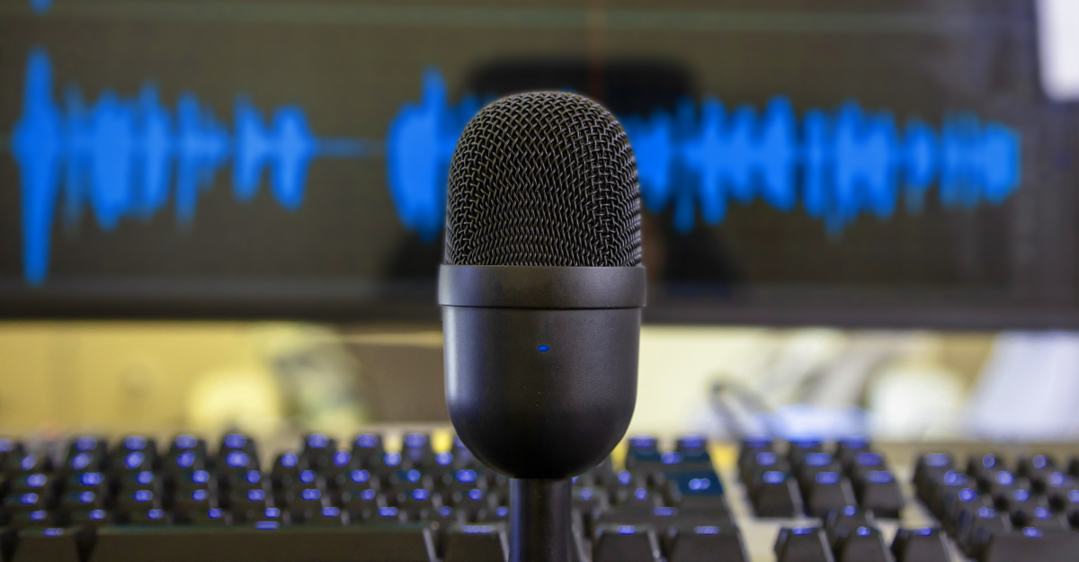 Microphone condenser metallic black, blur console and blue waveform background