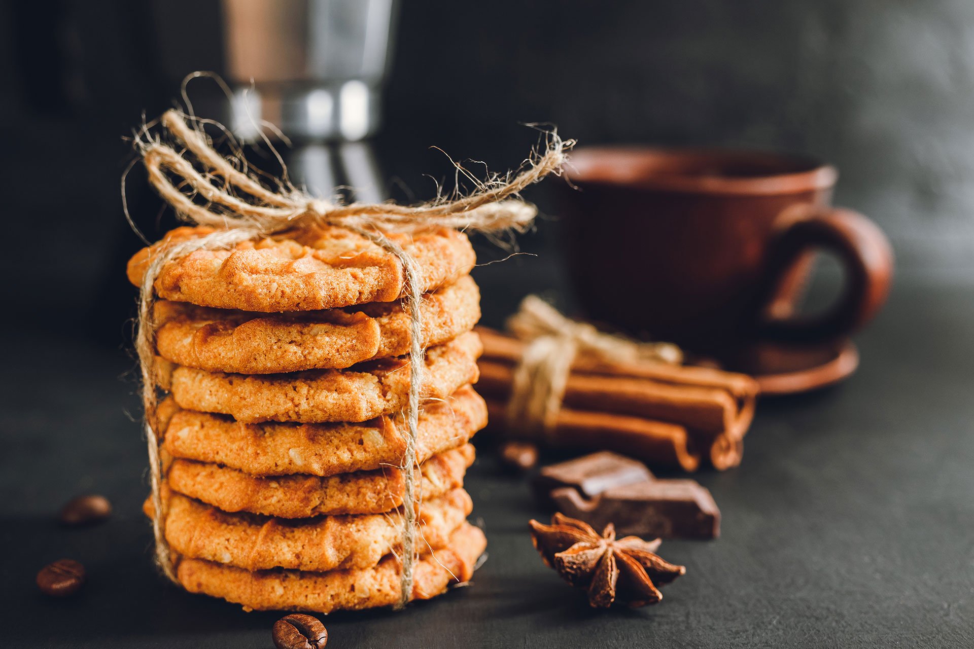 stack of cookies next to cinnamon pieces