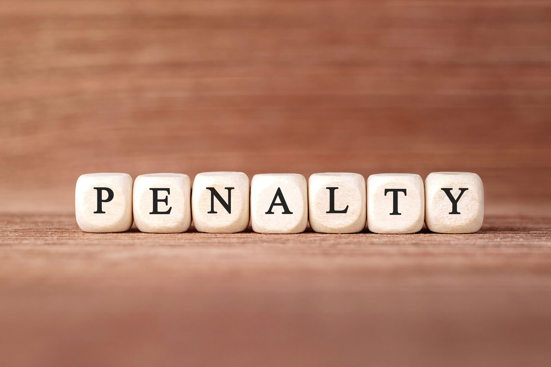 letter tiles spelling the word penalty