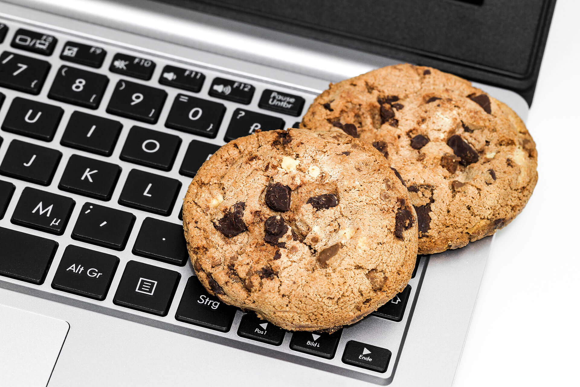 chocolate chip cookie on laptop keyboard