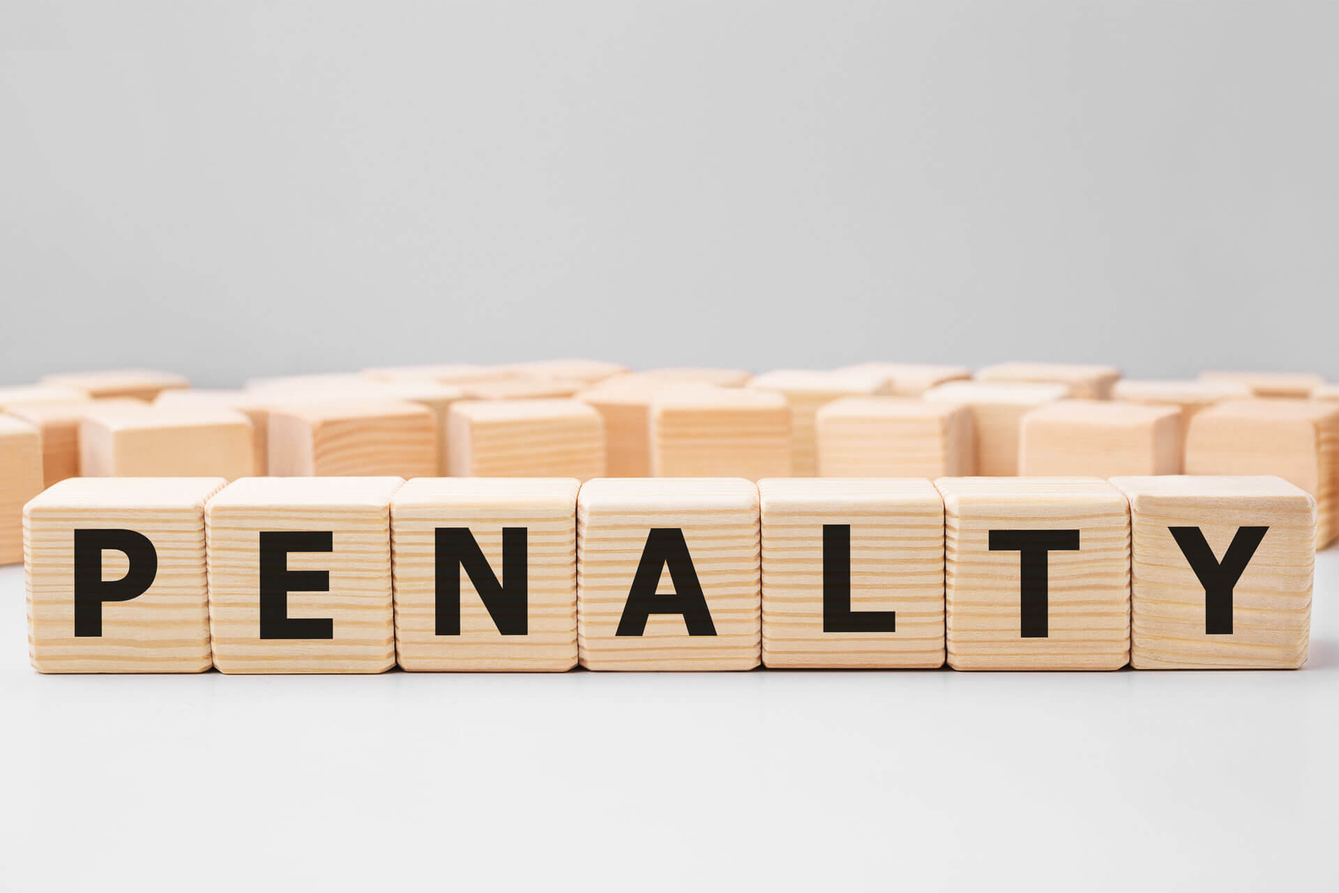 wooden blocks spelling the word penalty