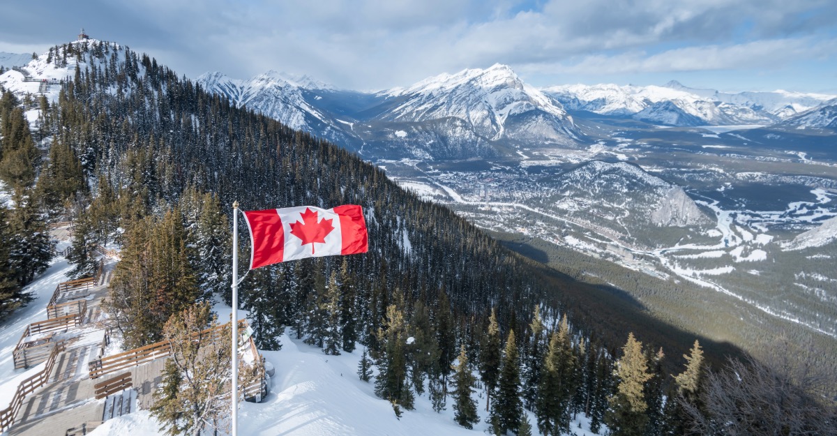 Canada flag with Banff national park, Alberta in the background