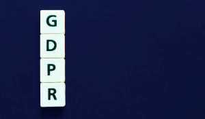 white letter tiles spelling GDPR on dark blue background
