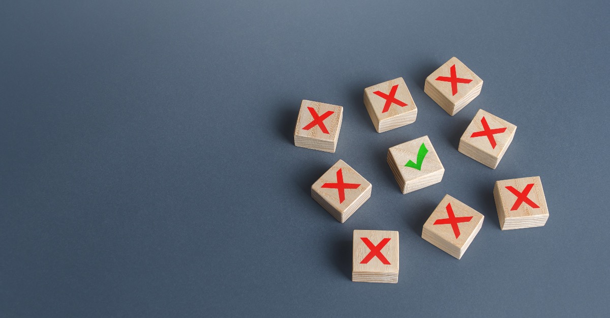 wooden blocks with red X on them surrounding one wooden block with the green checkmark on it