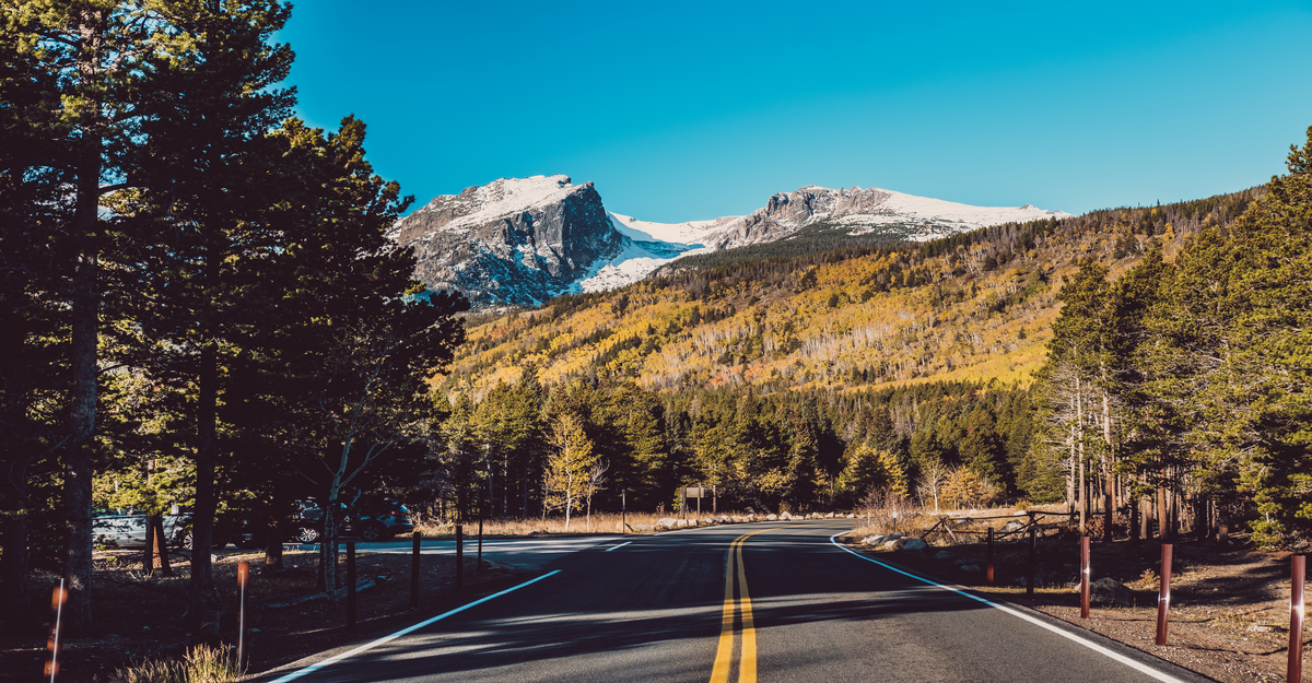 Highway at autumn sunny day in Rocky Mountain National Park. Colorado, USA.