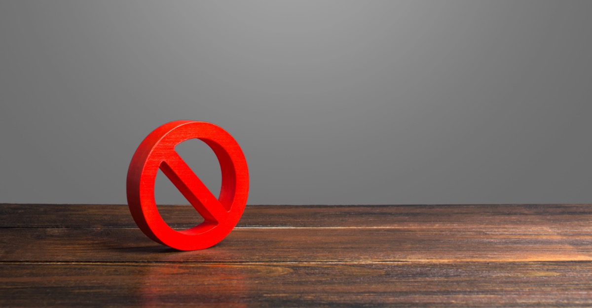 red refusal symbol symbolising opt-out on a wooden table